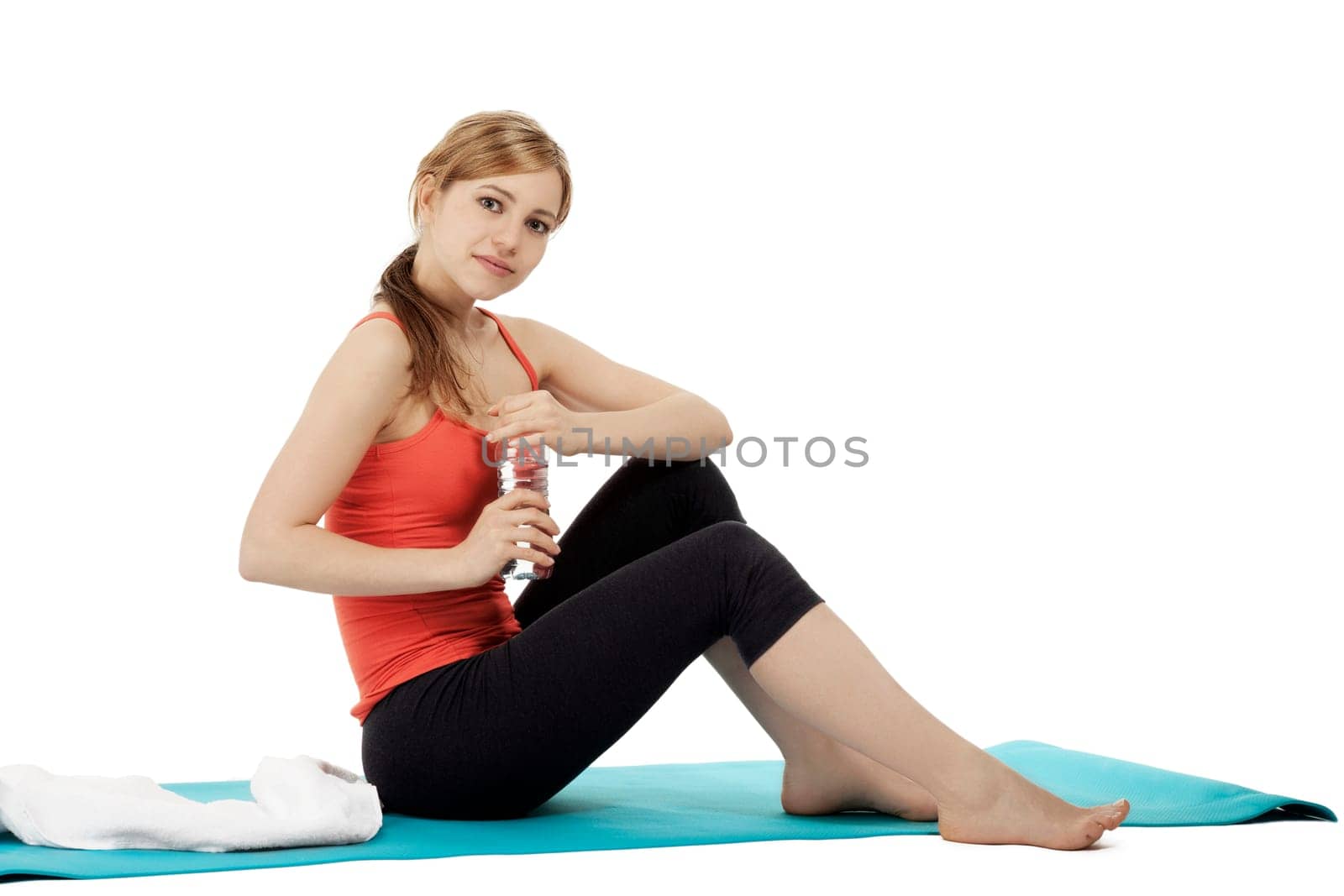 Young sportswoman taking break from fitness on white background