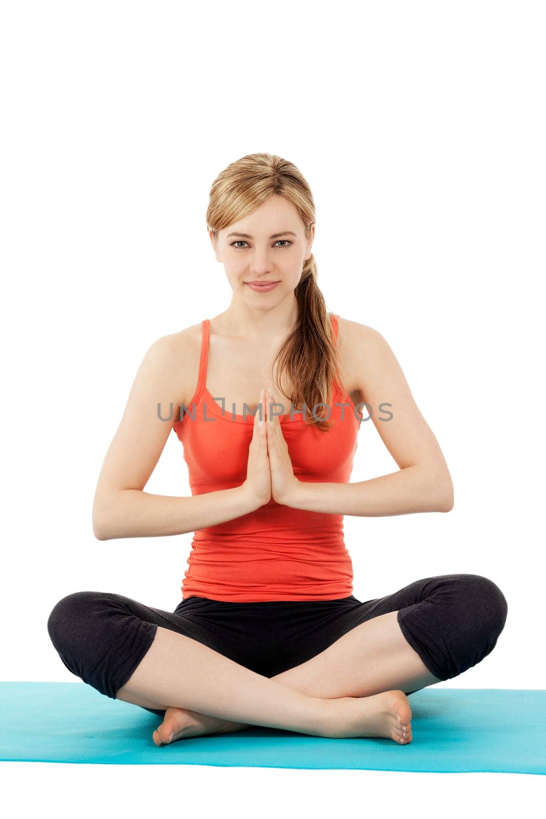 Young sportswoman doing yoga on white background