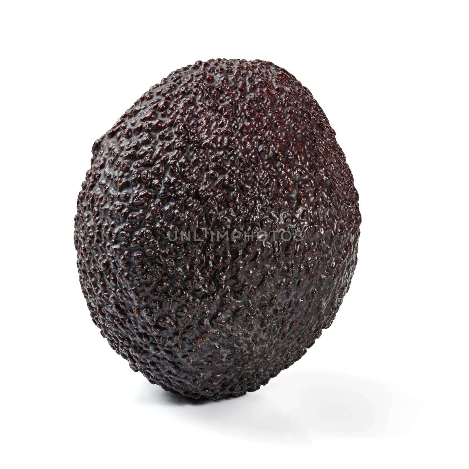 Single ripe dark brown (bilse variety) avocado isolated on white background by Ivanko