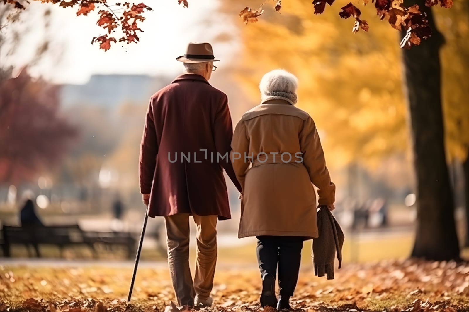 Rear view of a mature couple strolling through the park by audiznam2609