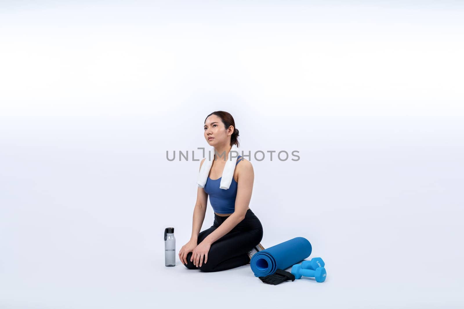 Athletic and sporty asian woman resting after intensive cardio workout training. Healthy exercising and fit body care lifestyle pursuit in studio shot isolated background. Vigorous