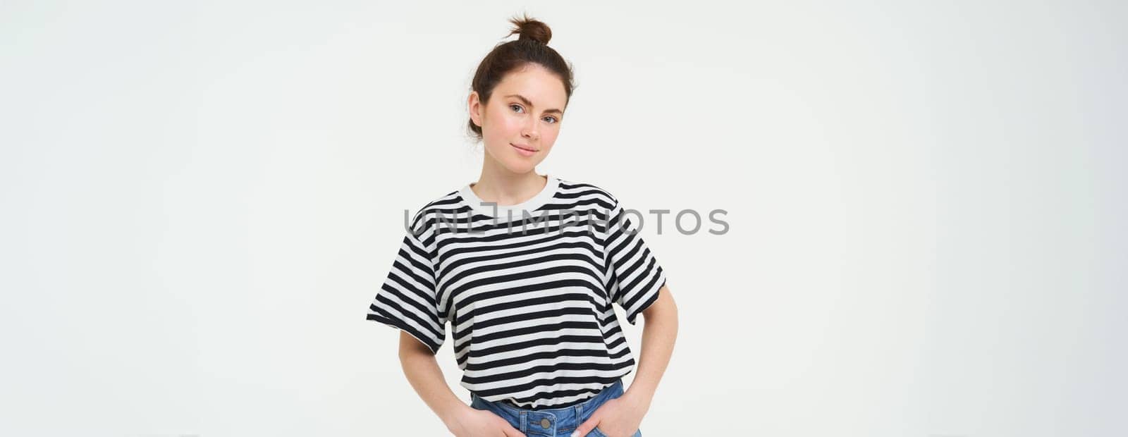 Image of young confident woman in casual outfit, looking happy, standing against white background by Benzoix