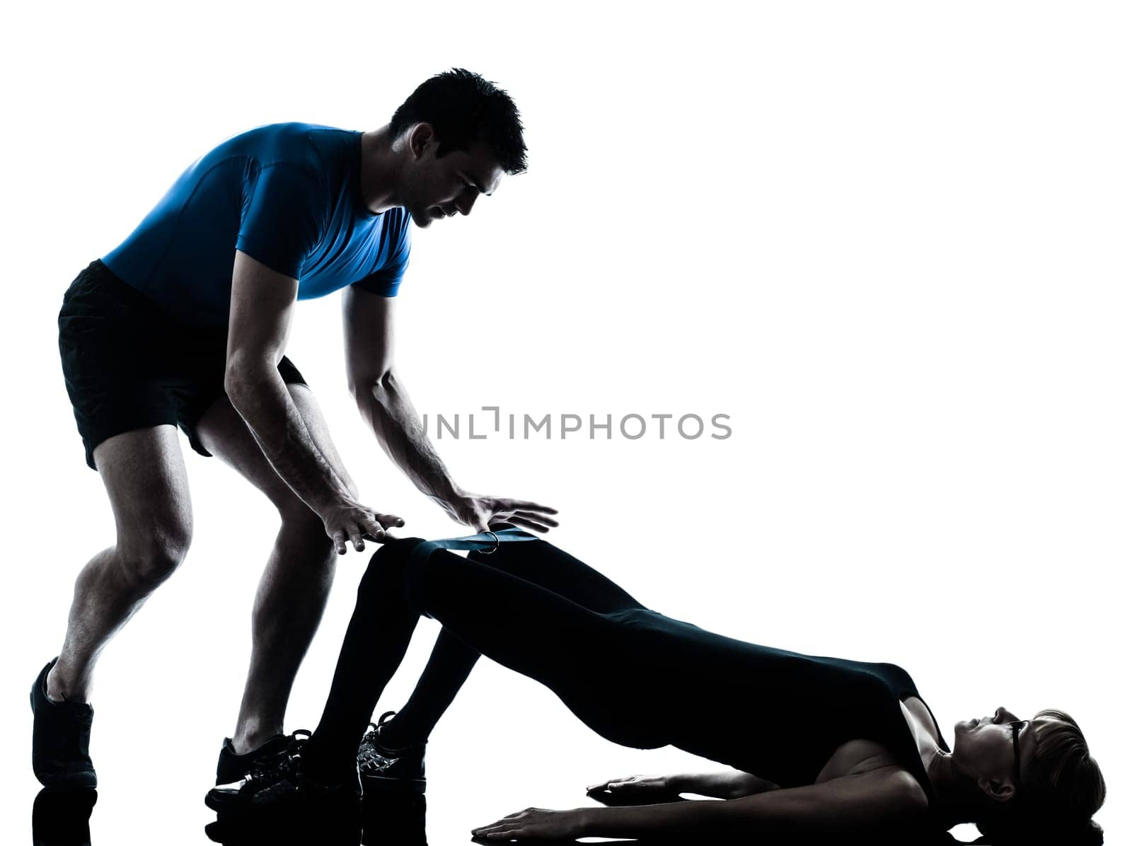 caucasian aerobics instructor  with mature woman exercising fitness workout in silhouette studio isolated on white background