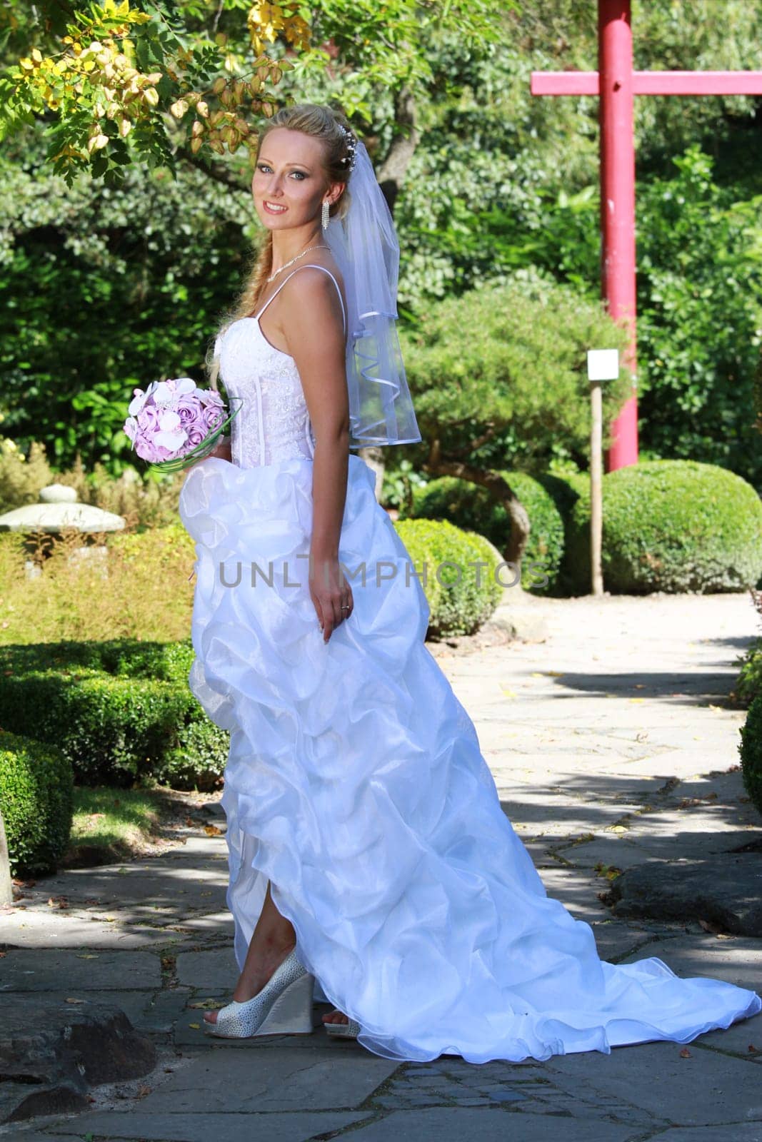 Bride in the park holding a bouquet
