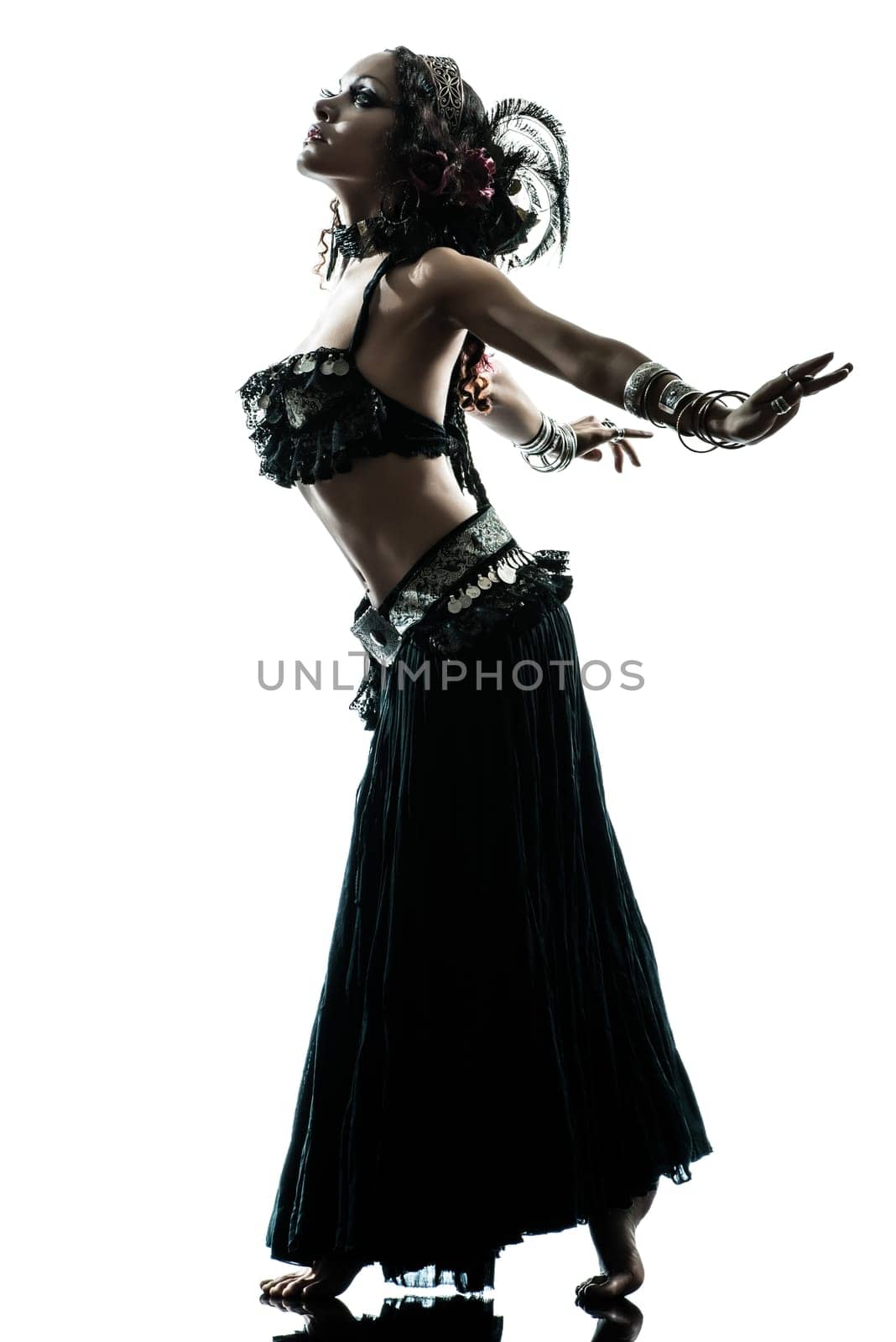 one arabic woman belly dancer dancing silhouette studio isolated on white background