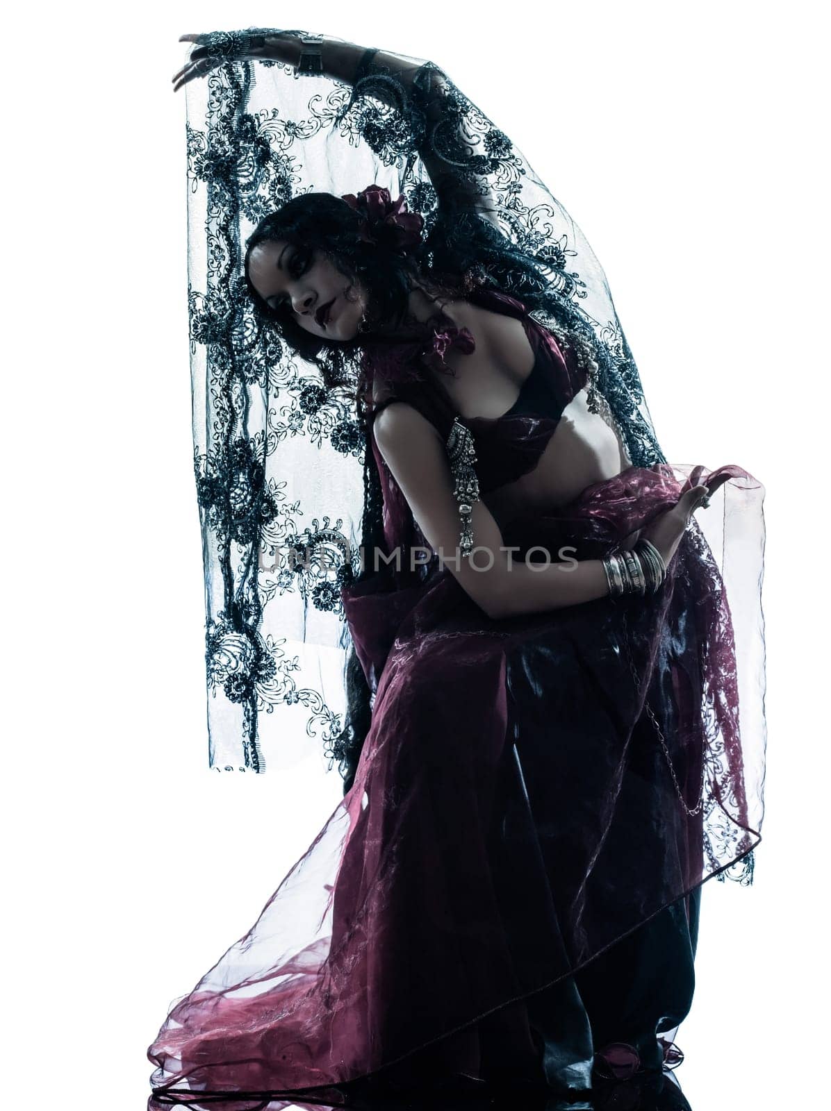 one arabic woman belly dancer dancing silhouette studio isolated on white background