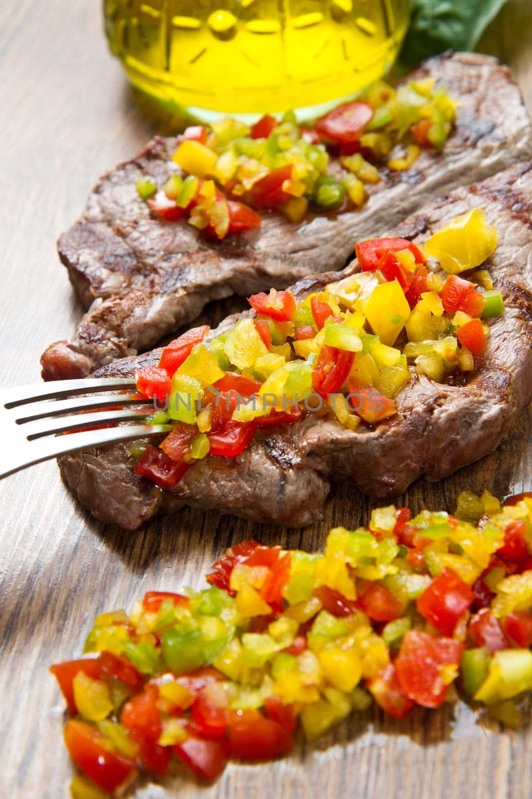 grilled steak meat with cut vegetables