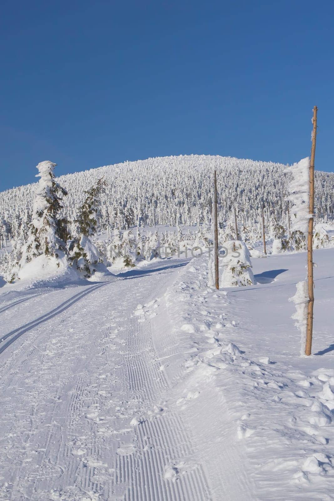 Winter mountain landscape scenery with cross country skiing way. Horizontally. (Mountains Jeseniky, Czech Republic)