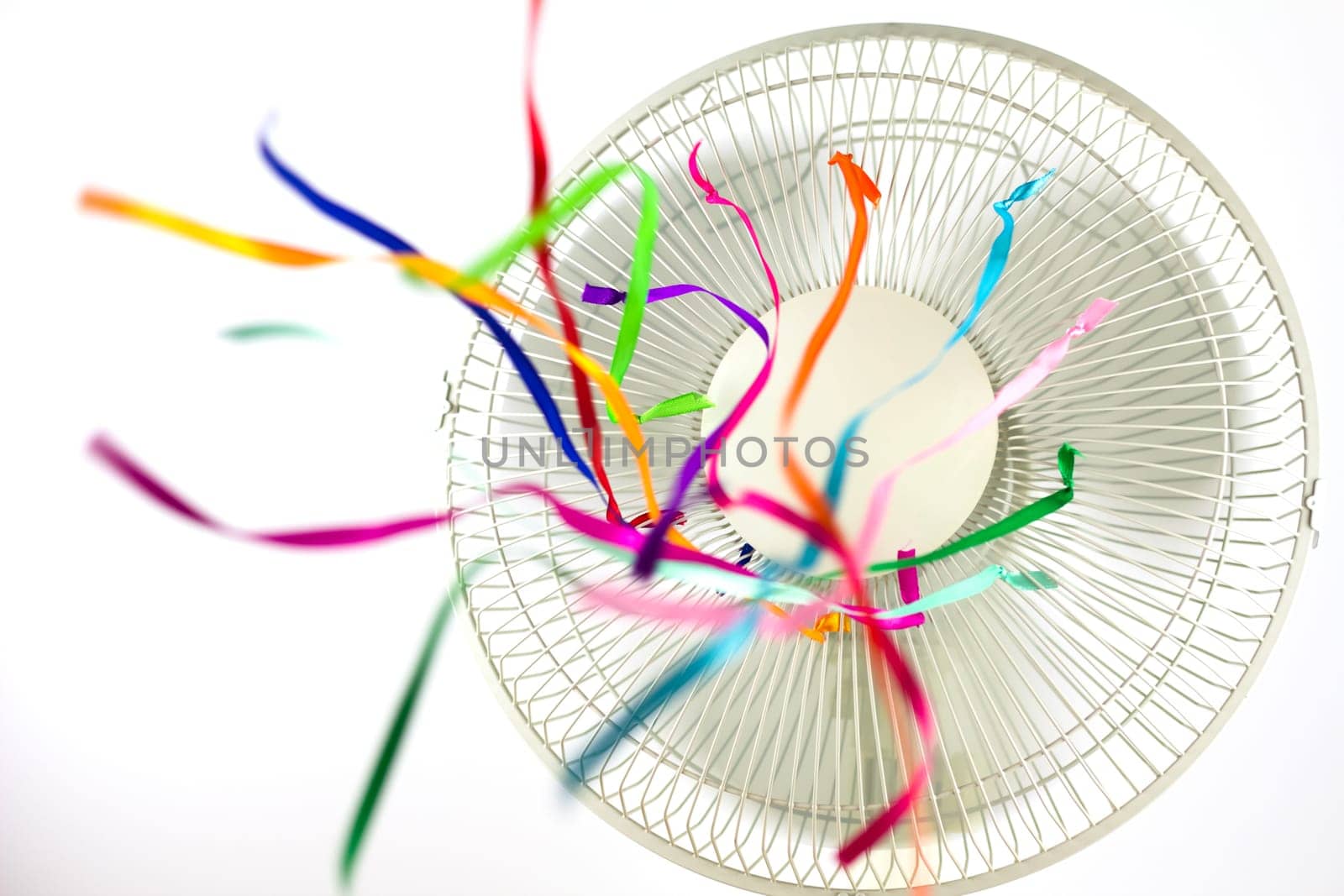 An electric fan blowing silk ribbons