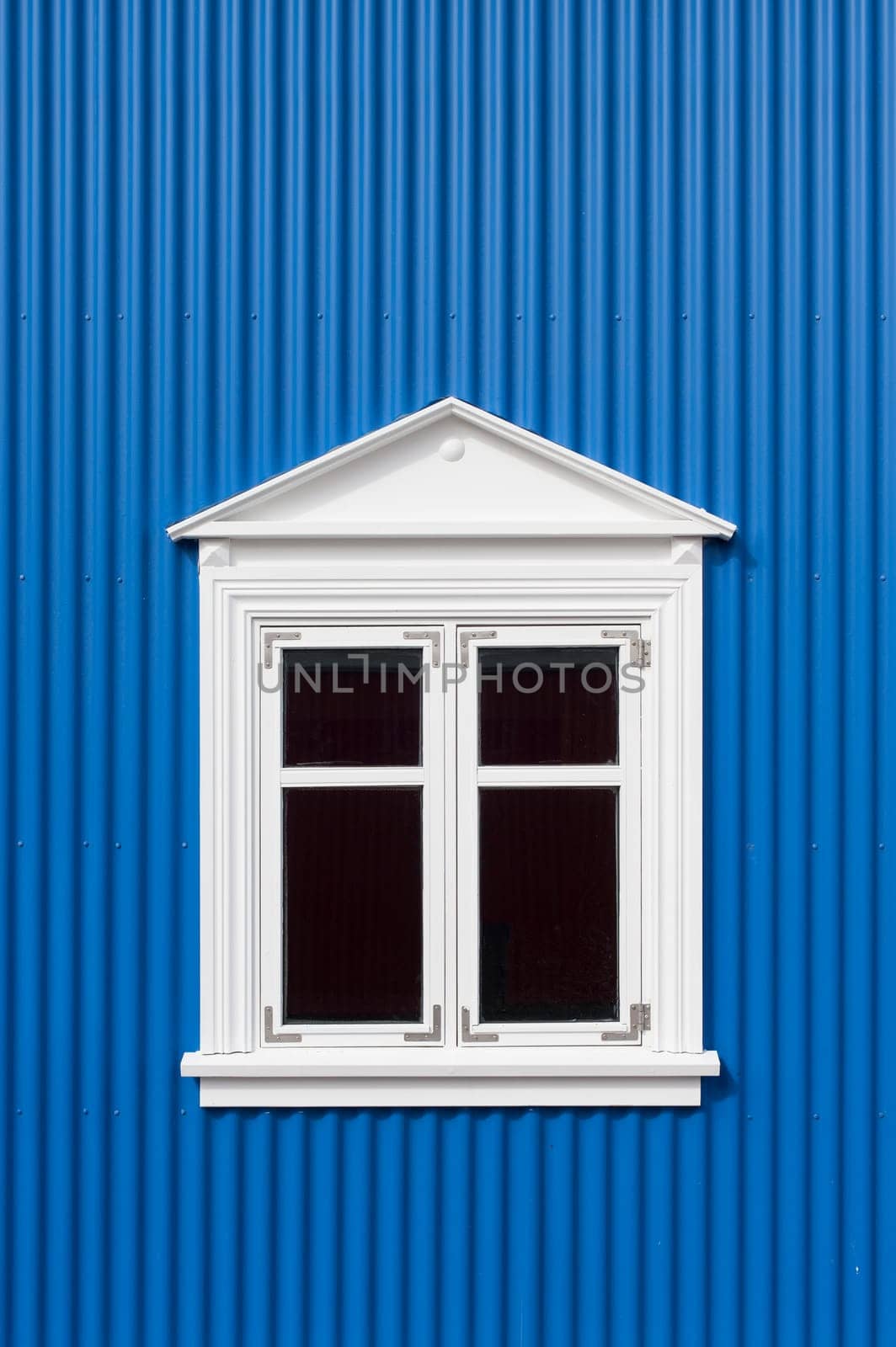 New blue corrugated wall with a white window