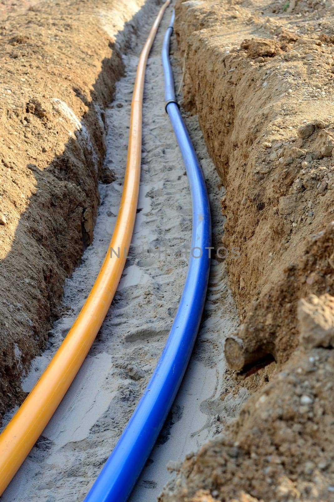 Gas and water pipes in open trenches