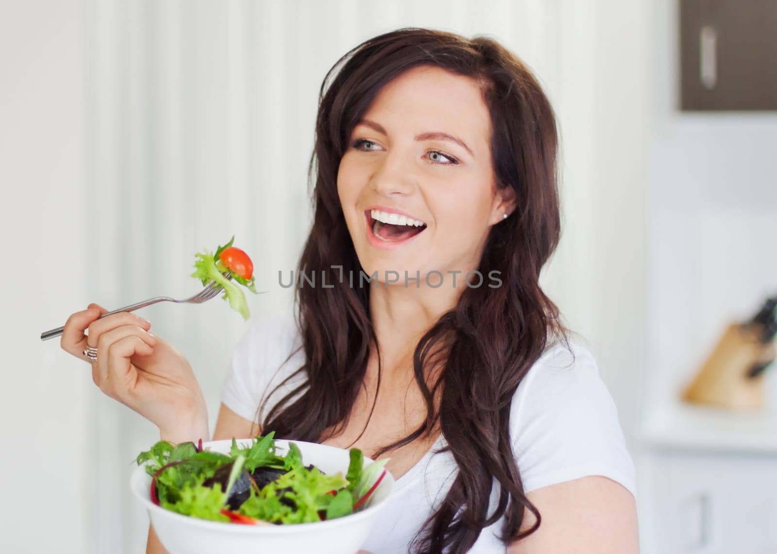 Attractive young woman eating a healthy salad