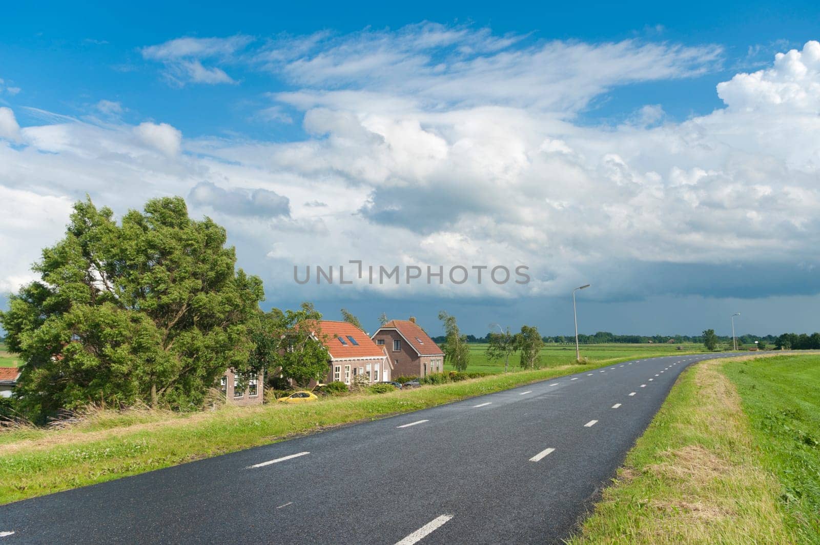 road over a dyke in a typical dutch polder landscape