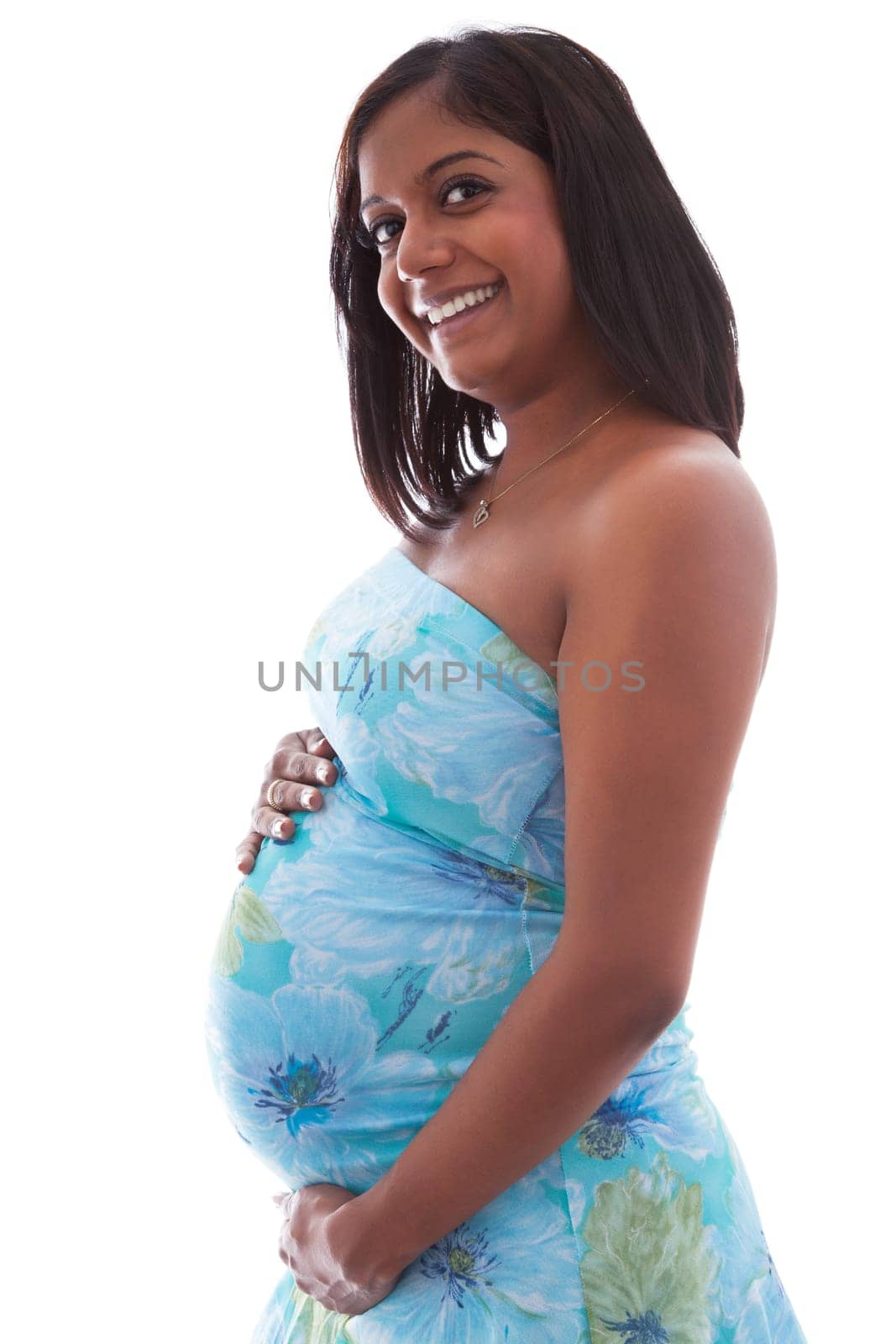 Young beautiful pregnant indian woman touching her belly
