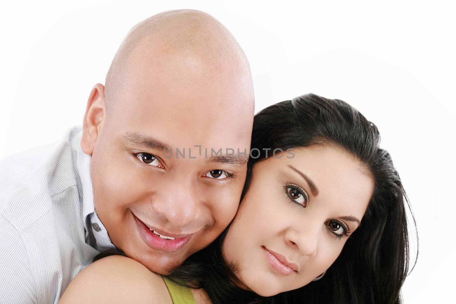Portrait of a beautiful young happy smiling couple - isolated