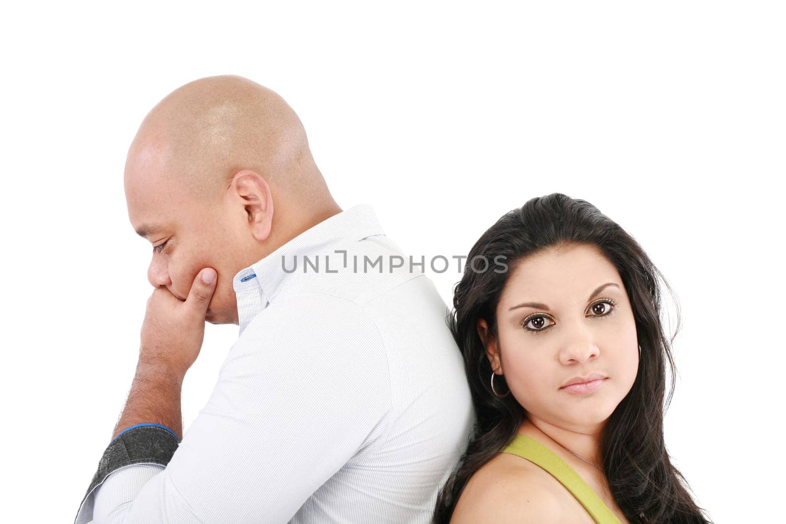Young couple standing back to back having relationship difficulties on white background