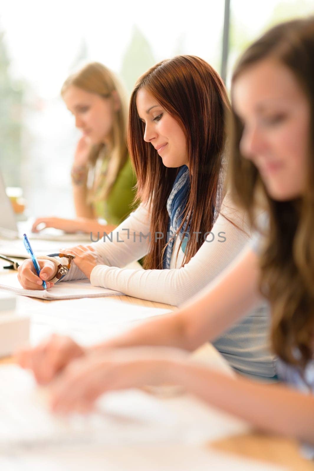 Student teenager studying at classroom sitting in a row