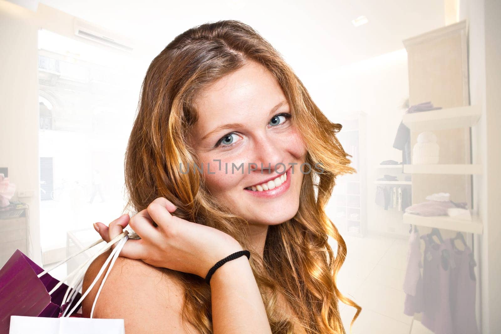 Smiling girl with shopping bags