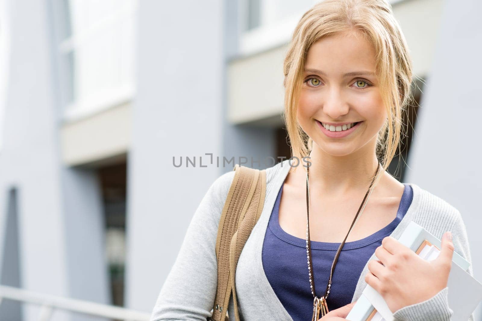 Young happy woman holding books to school smiling education student