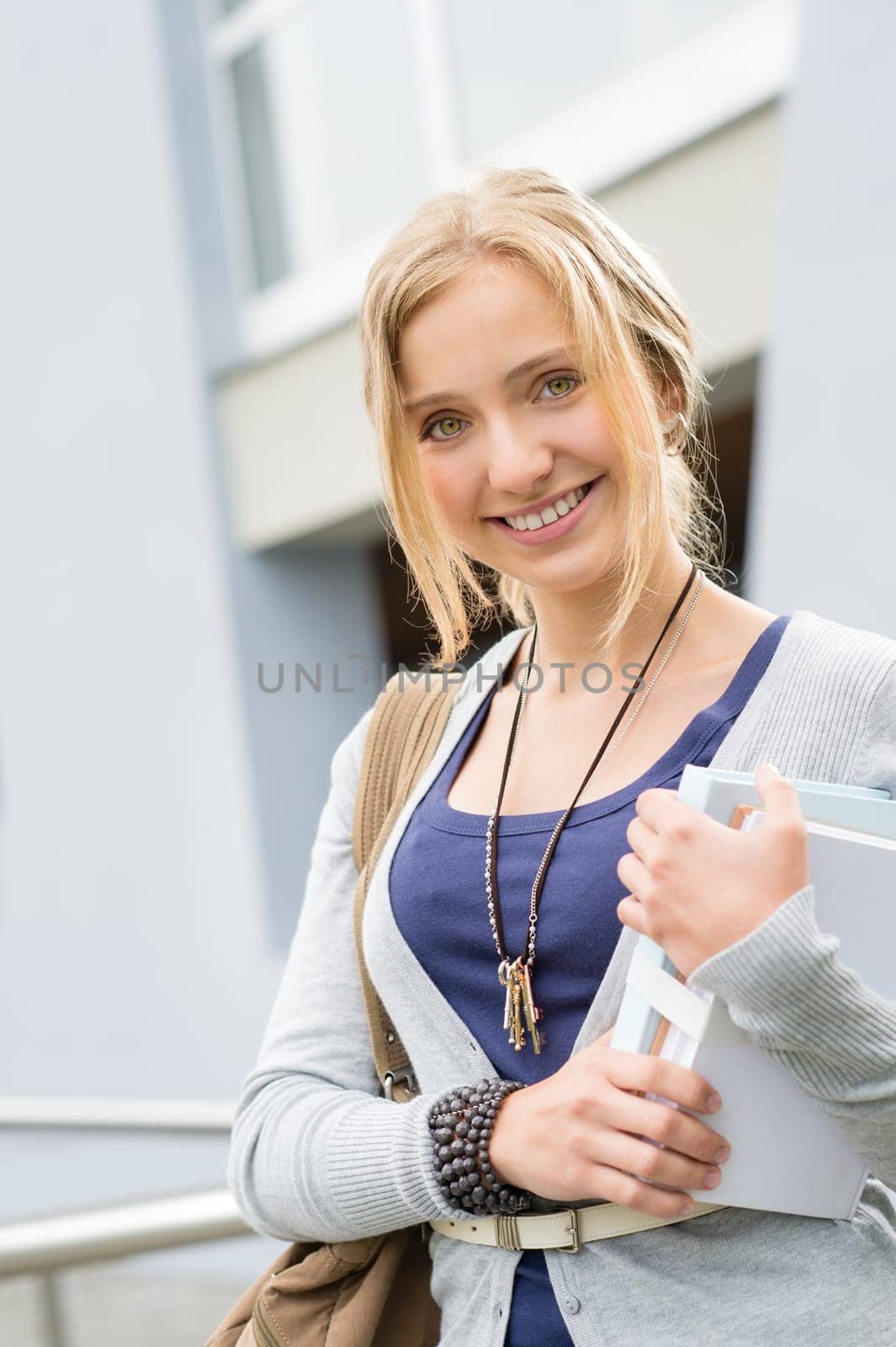 Young happy student holding books to school smiling education girl