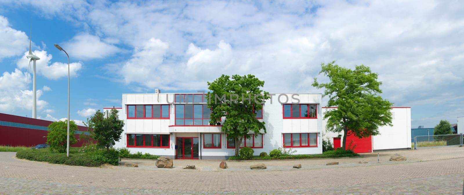modern white office building with red windows