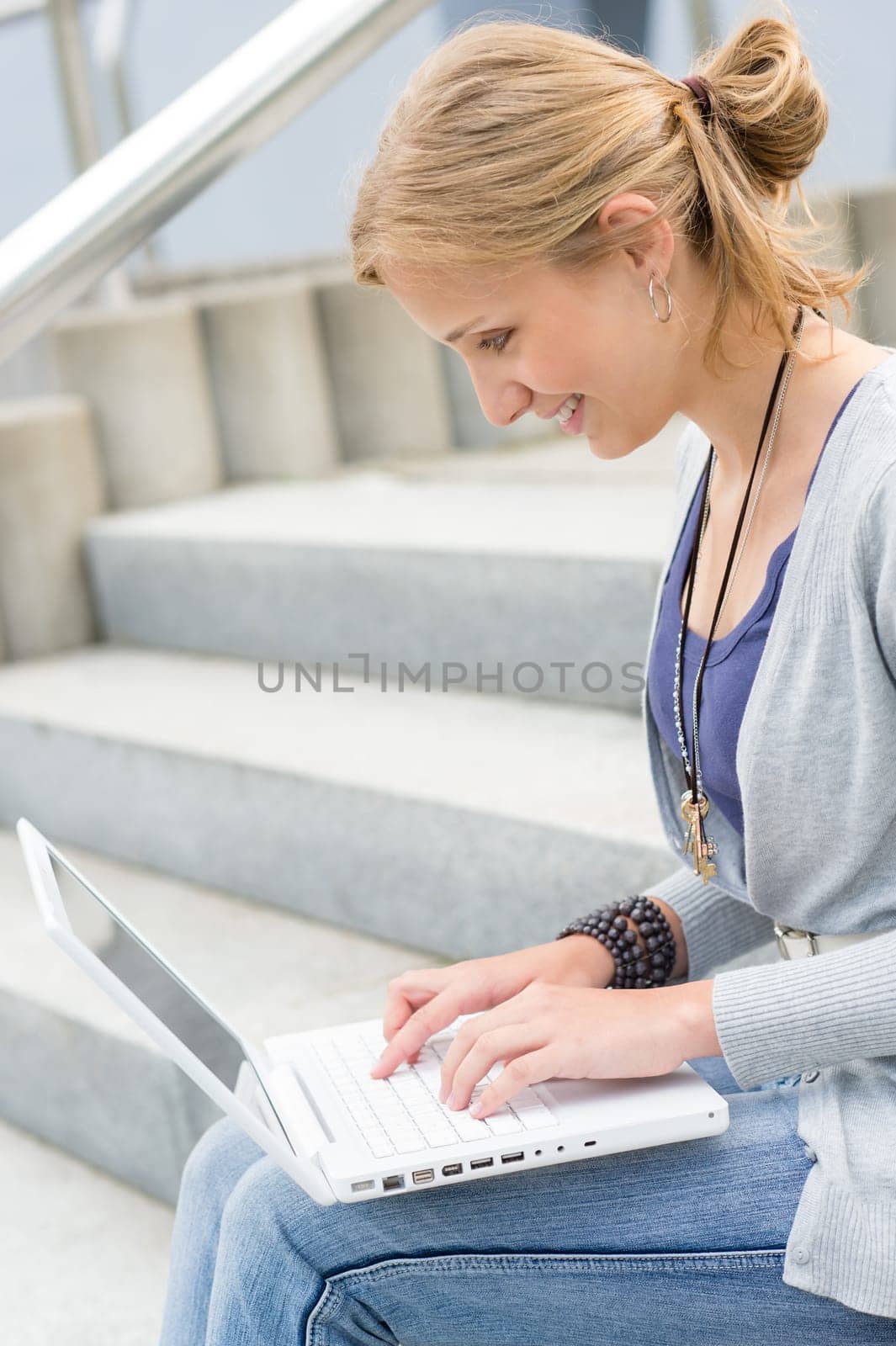 Young woman working on her laptop computer student happy smiling