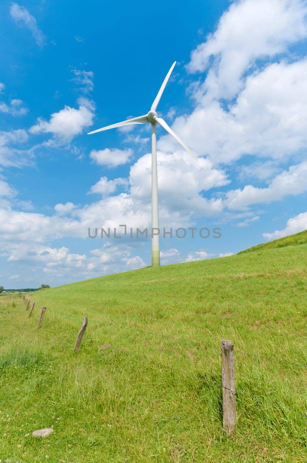 wind turbine on a green hill
