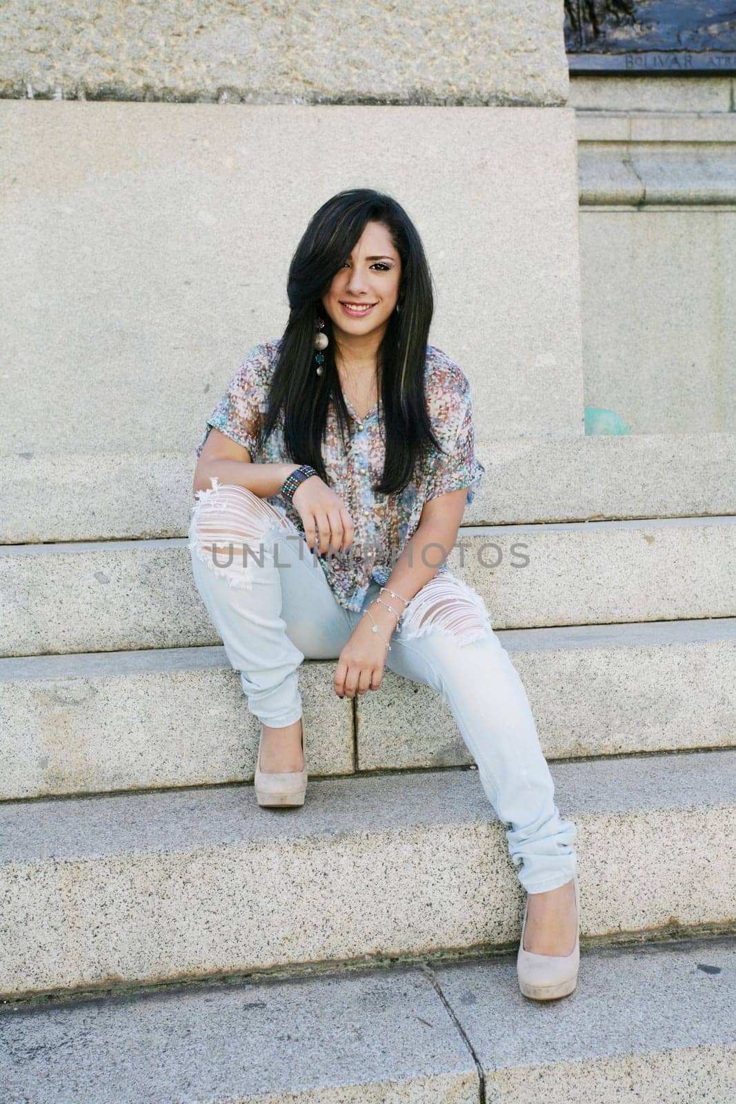 Beautiful girl sitting on stairs