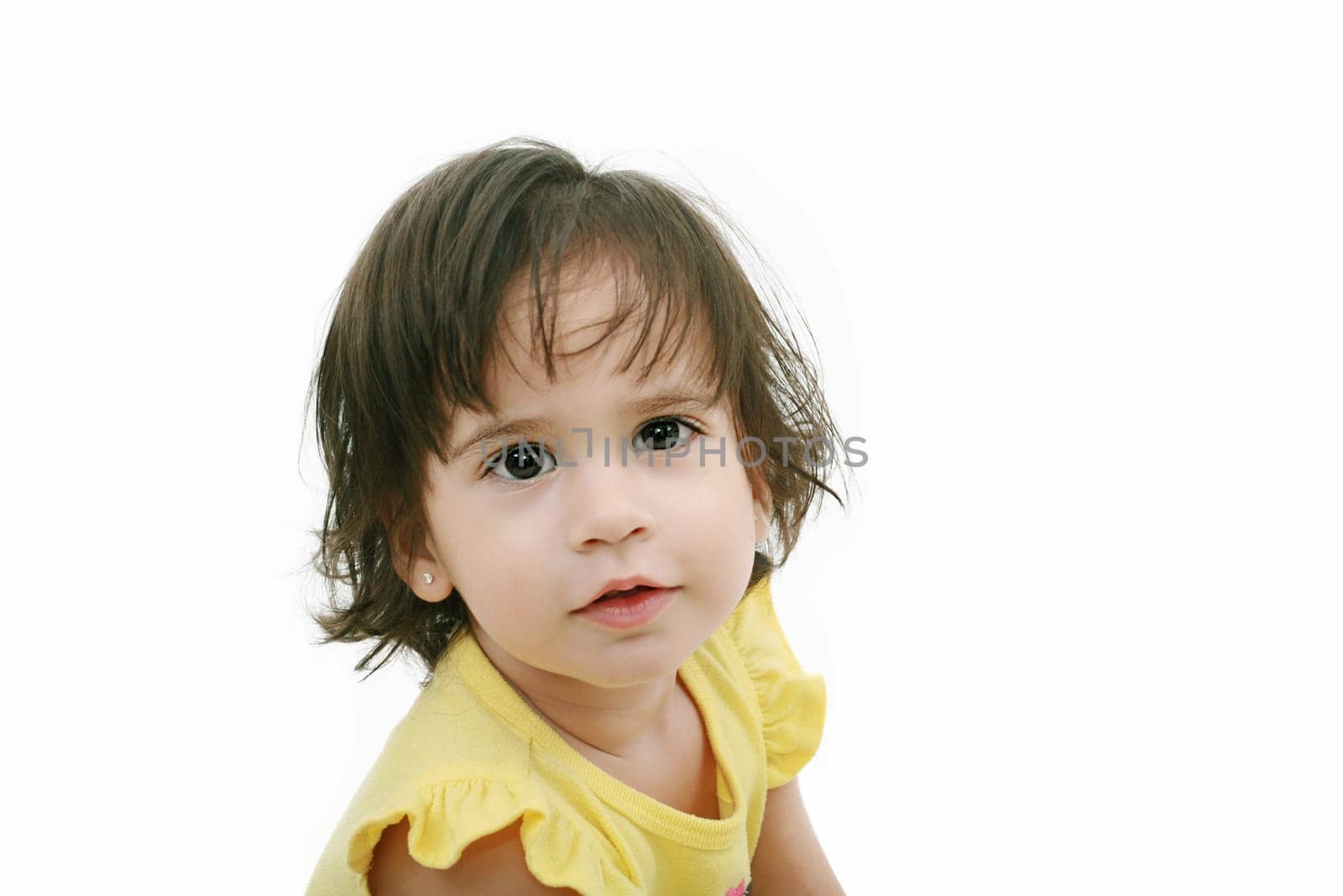 Photo of adorable young girl looking at camera