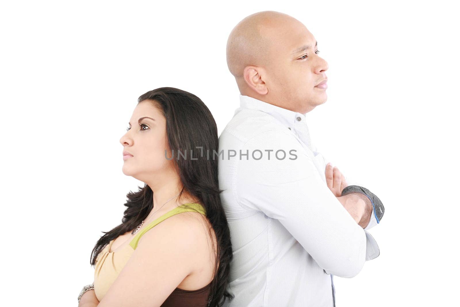 Young couple standing back to back having relationship difficulties on white background