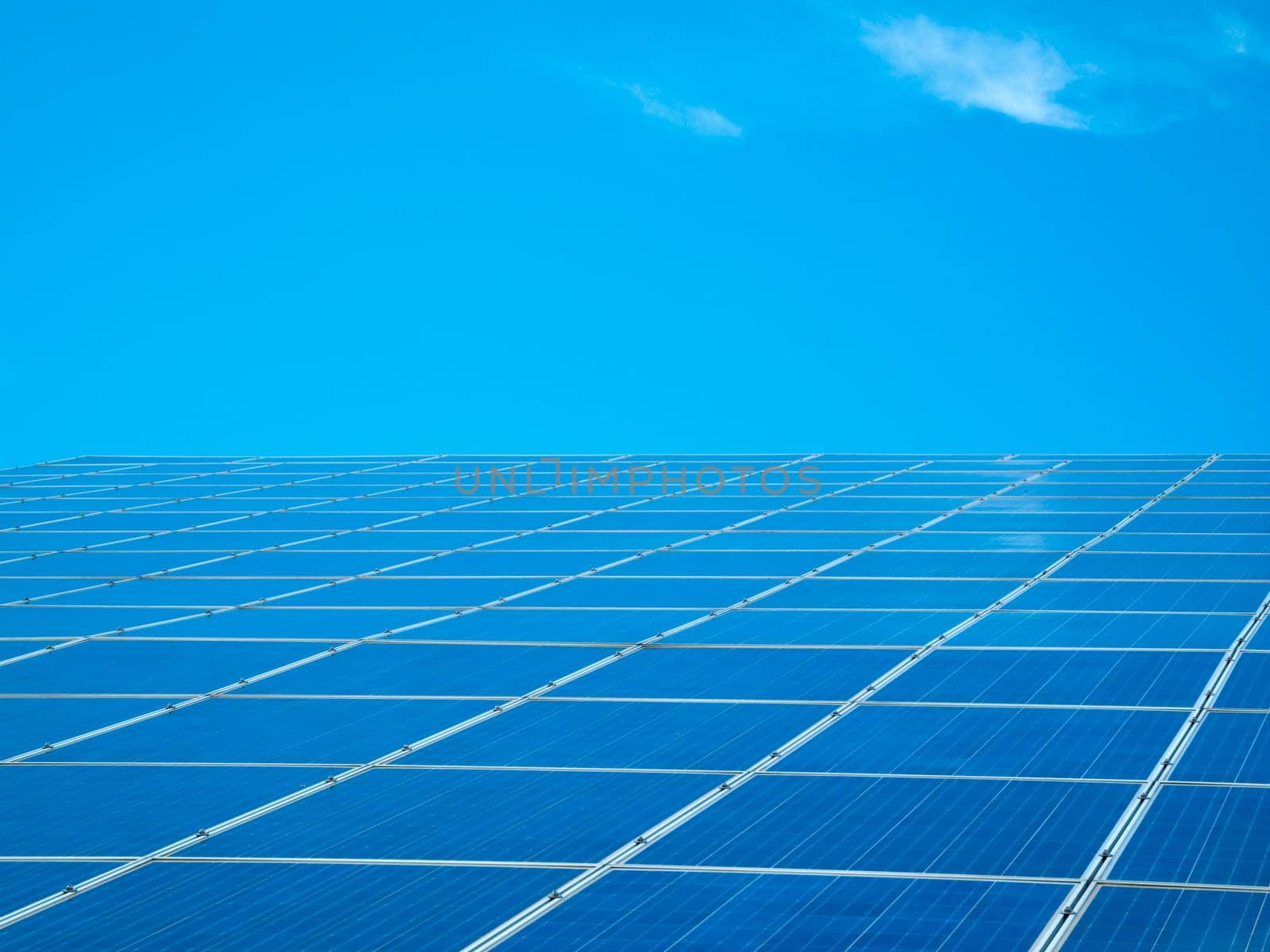 Photovoltaic system with blue sky and scattered clouds