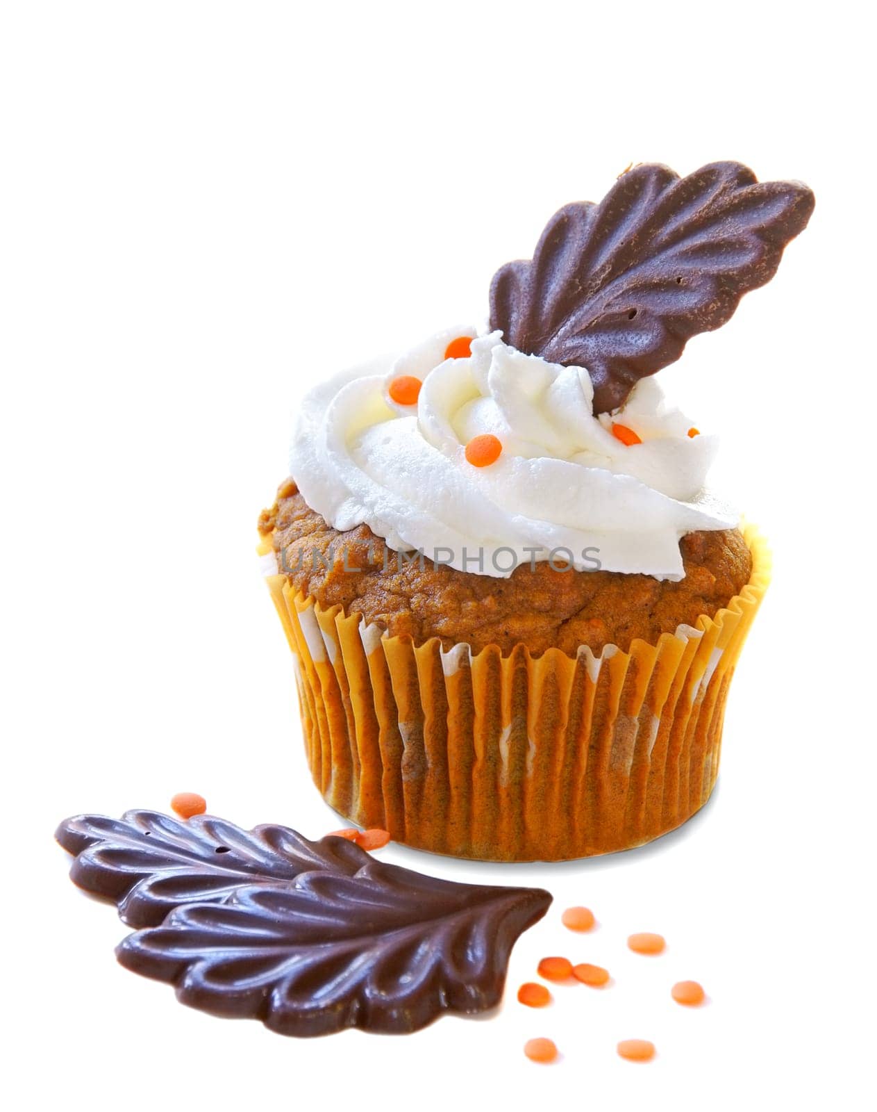 Autumn decorated cupcake with chocolate leaves and orange sprinkles