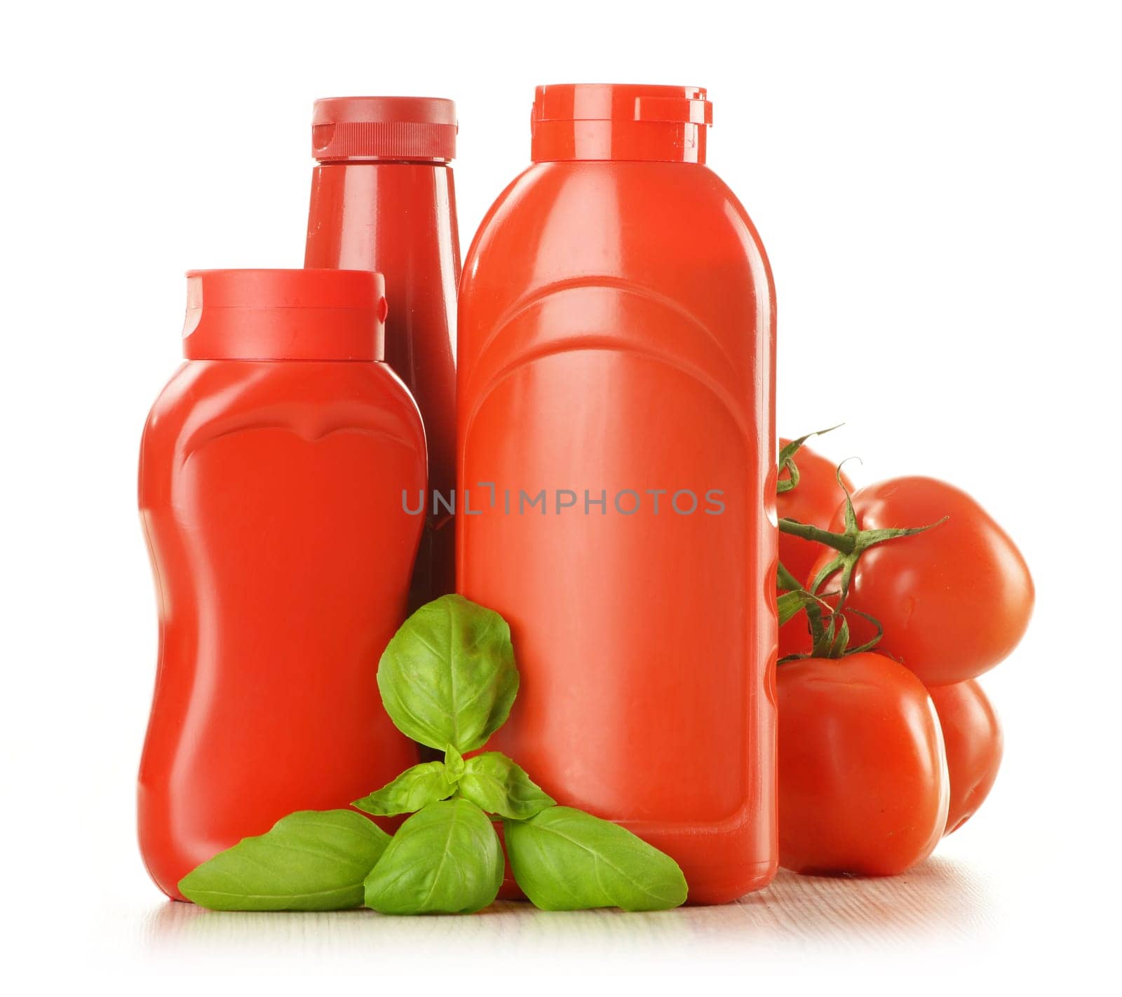 Composition with ketchup and fresh tomatoes isolated on white