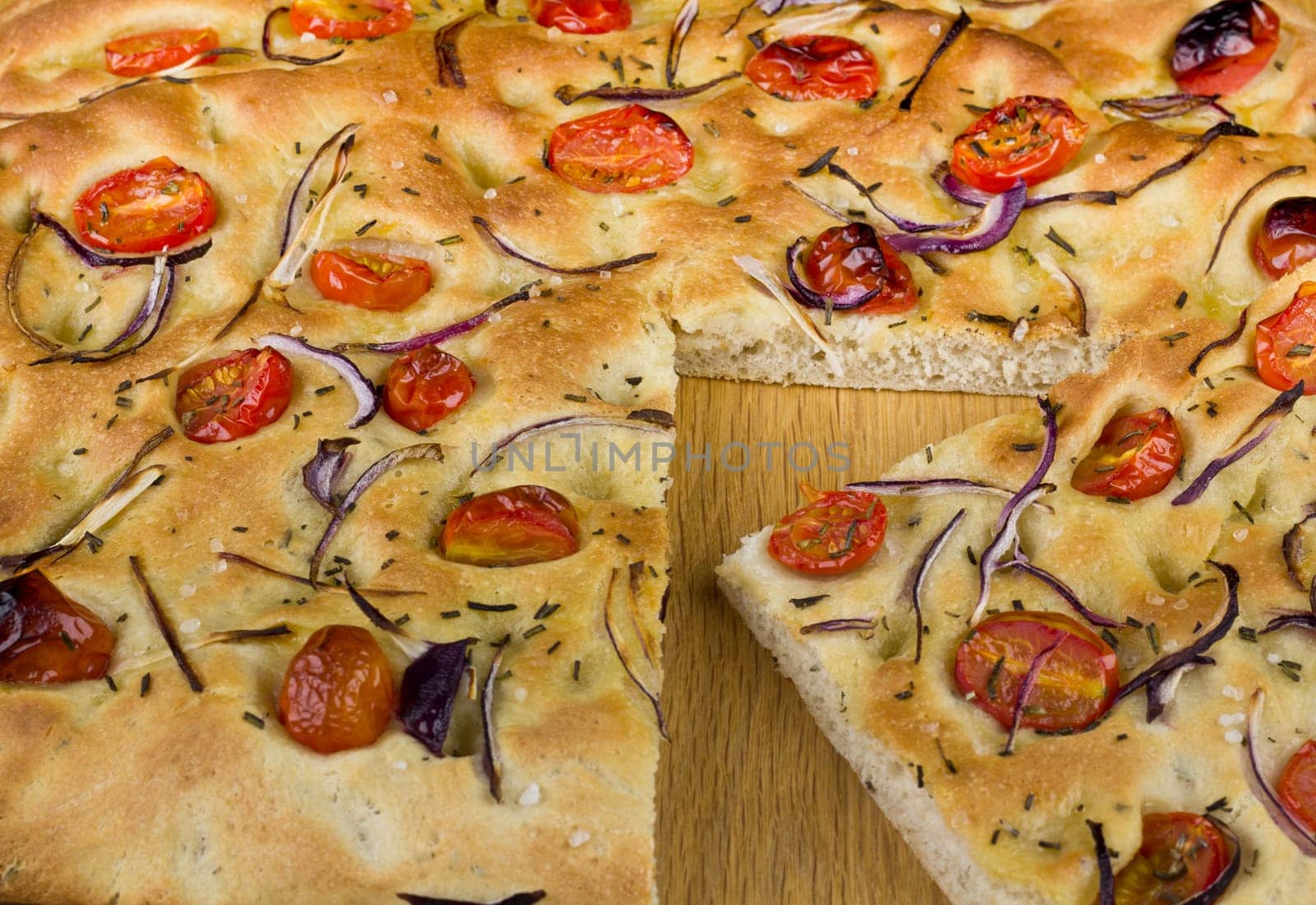 A sclice from a loaf of fresh Foccacia Bread