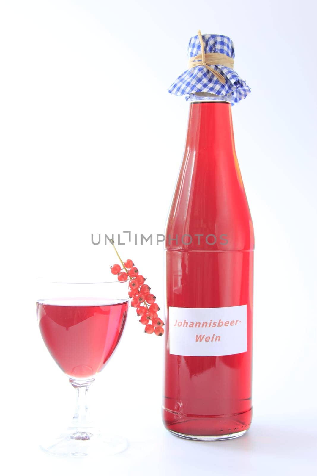 Red Currant Fruit Wine With Bottle And Glass Isolated Against Neutral Background