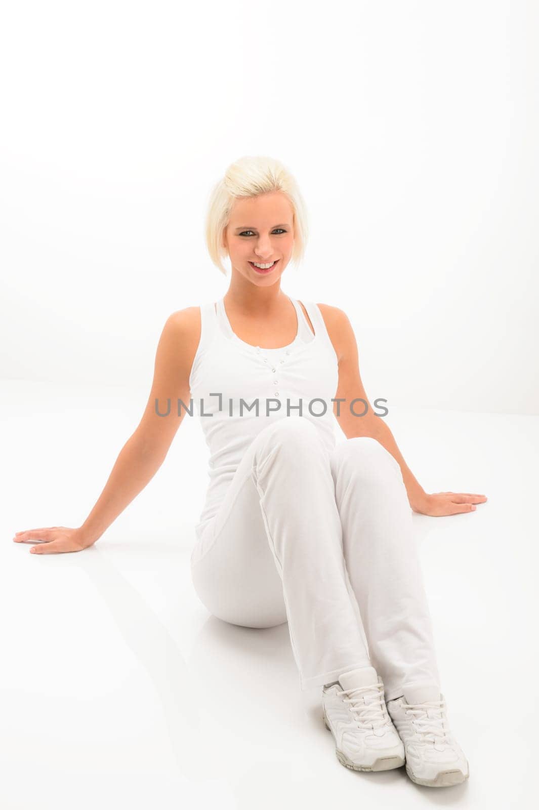 Fitness blonde woman relax during Pilates exercise isolated on white