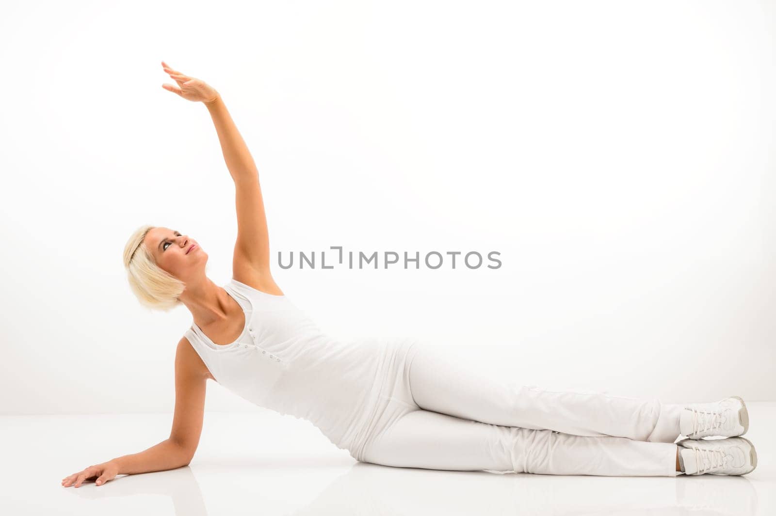 Woman stretching her arm fitness yoga exercise workout white background