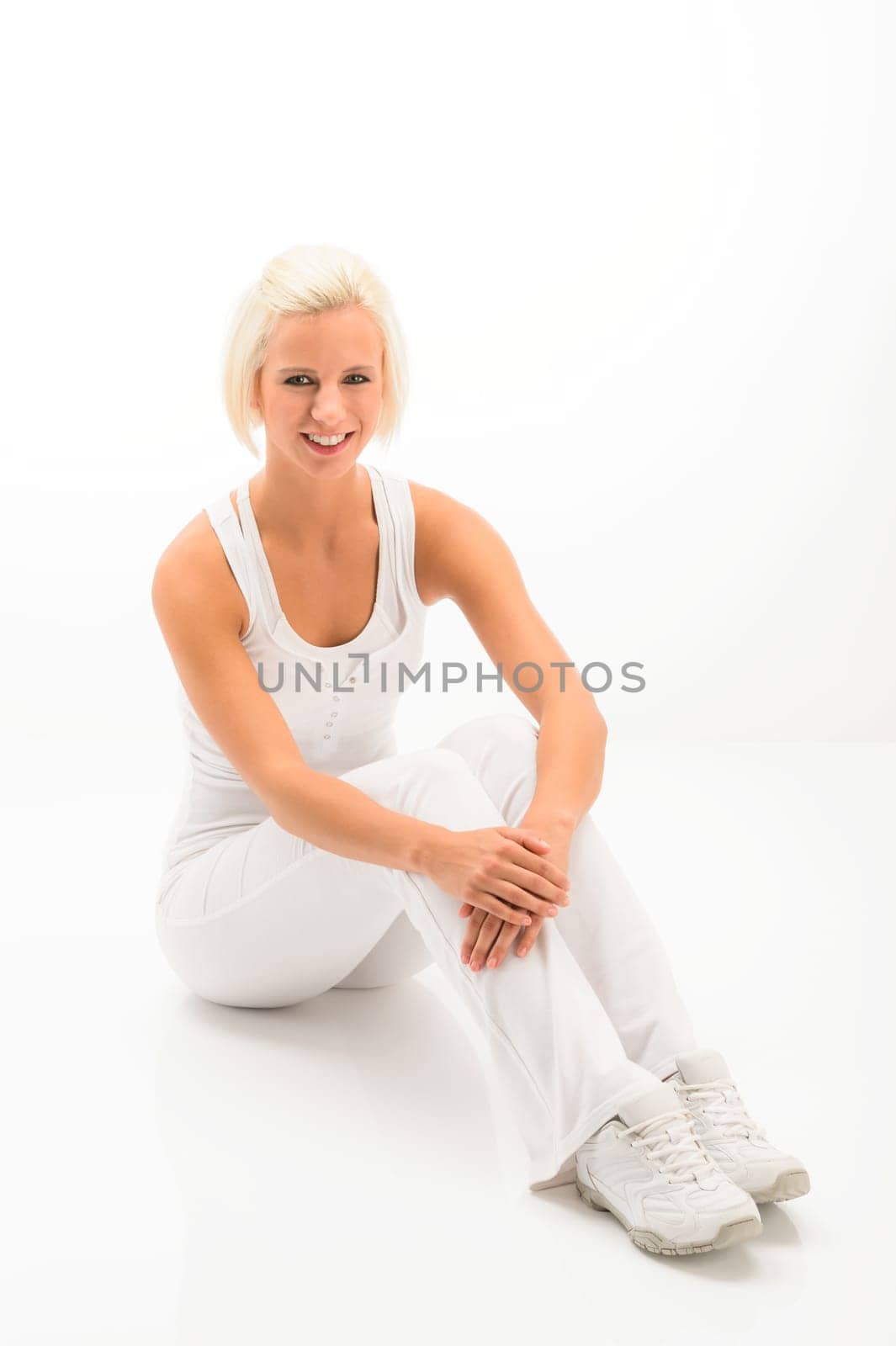 Fitness blonde woman relax during Pilates exercise isolated on white