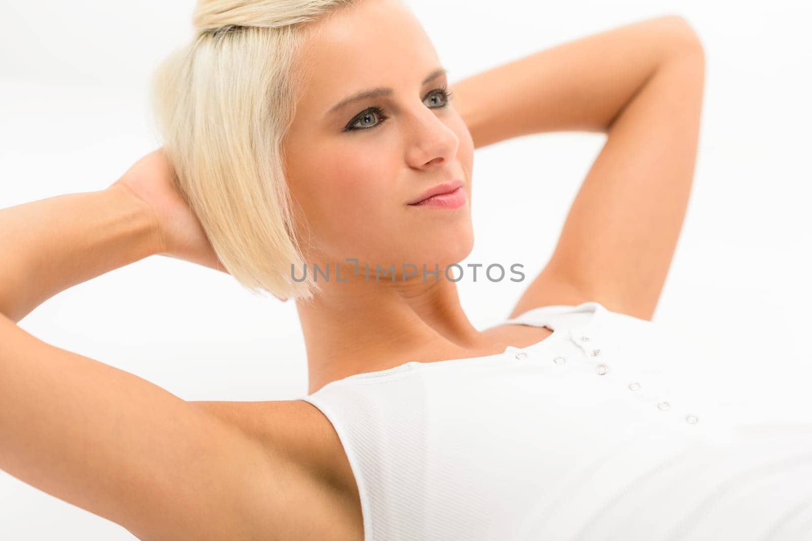 Fit woman doing sit-ups exercise abdominal workout isolated on white