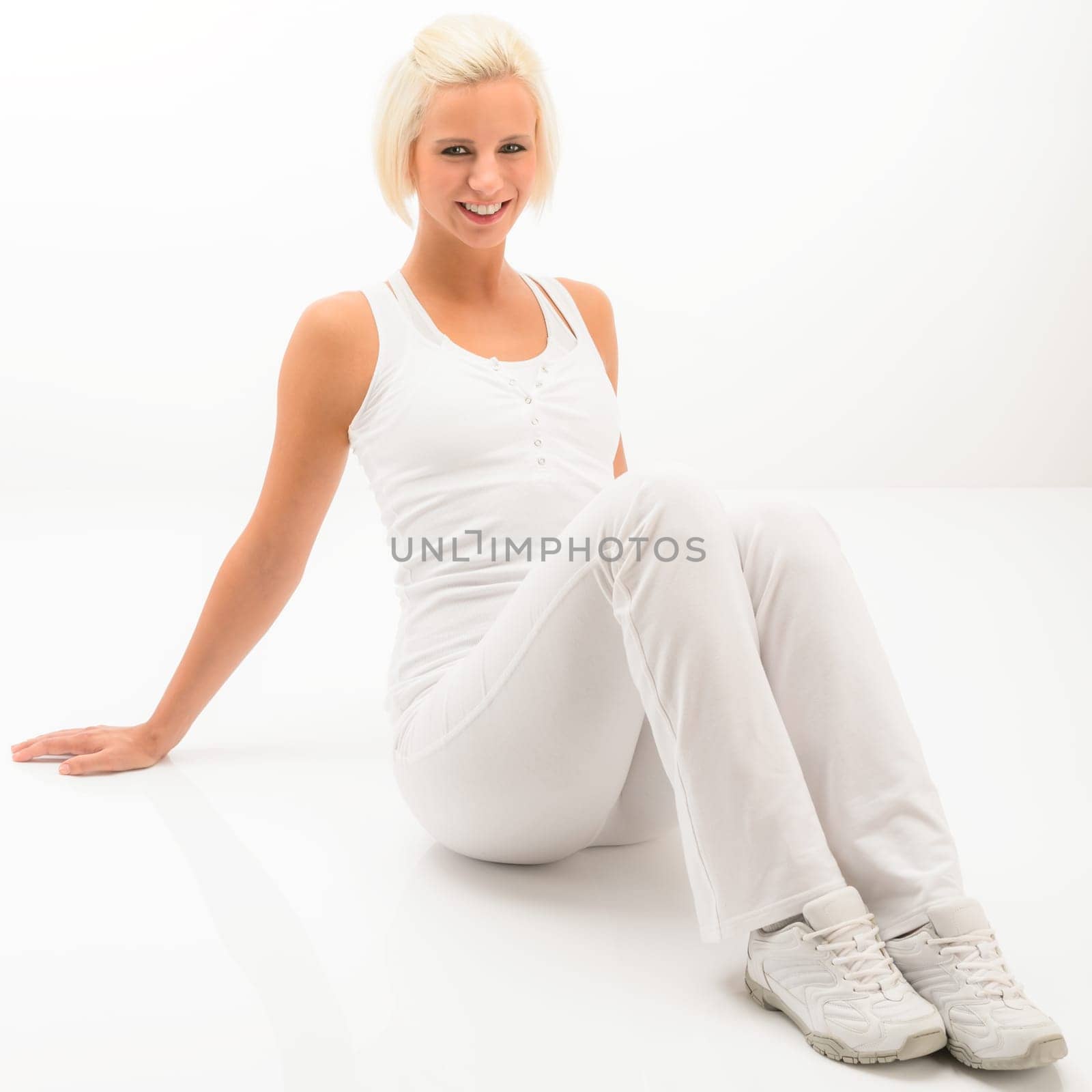 Fitness blonde woman relax during Pilates exercise isolated on white