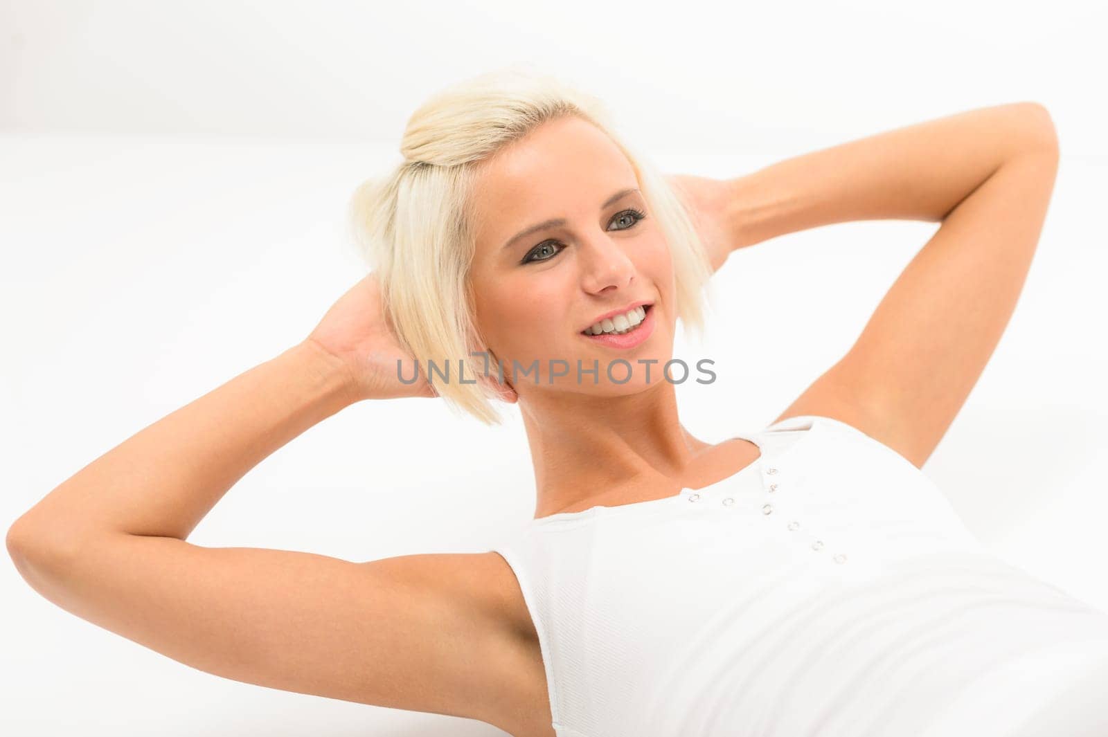 Fit woman doing sit-ups exercise abdominal workout isolated on white