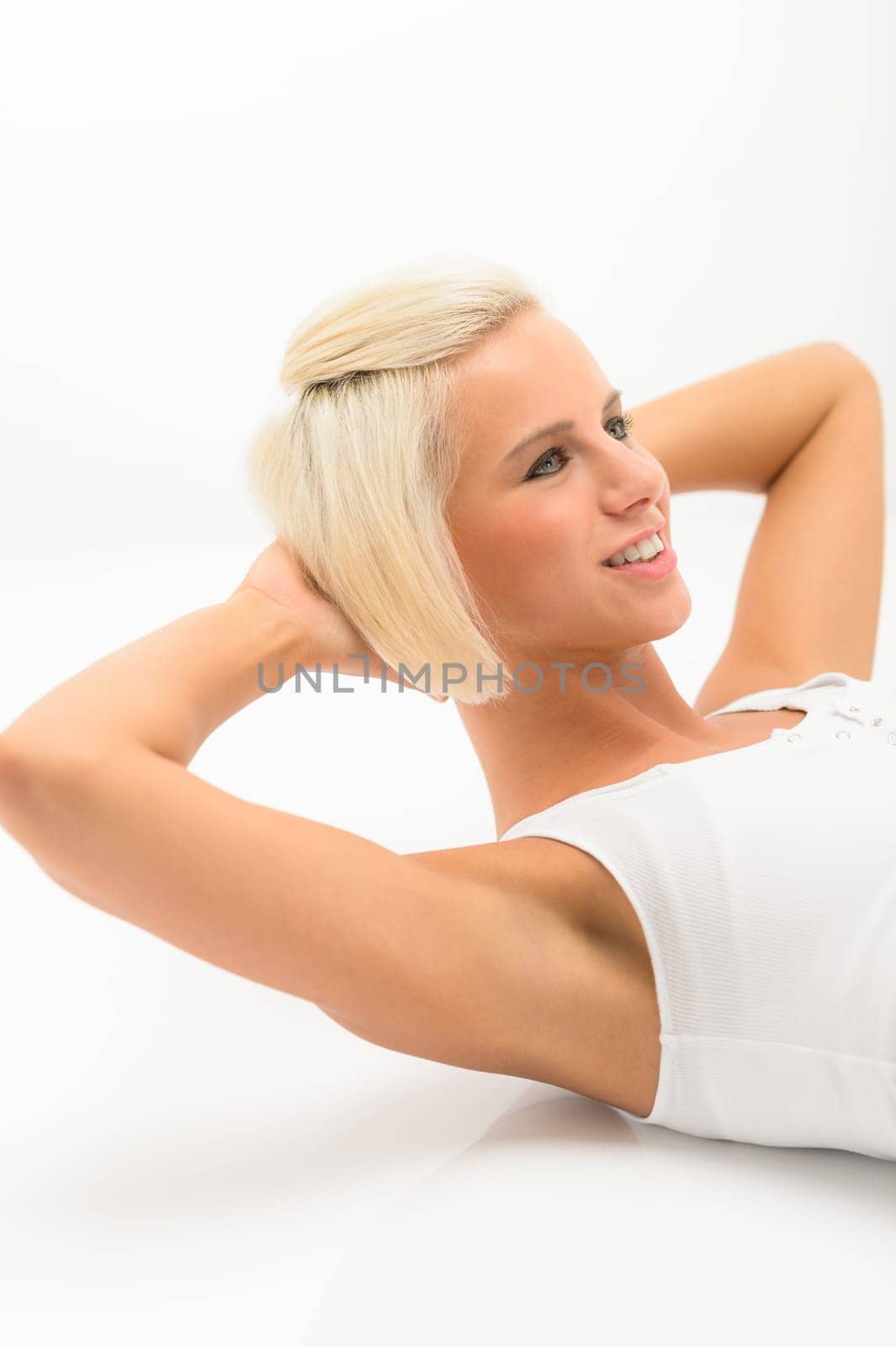 Fit woman doing sit-ups exercise abdominal workout isolated on white