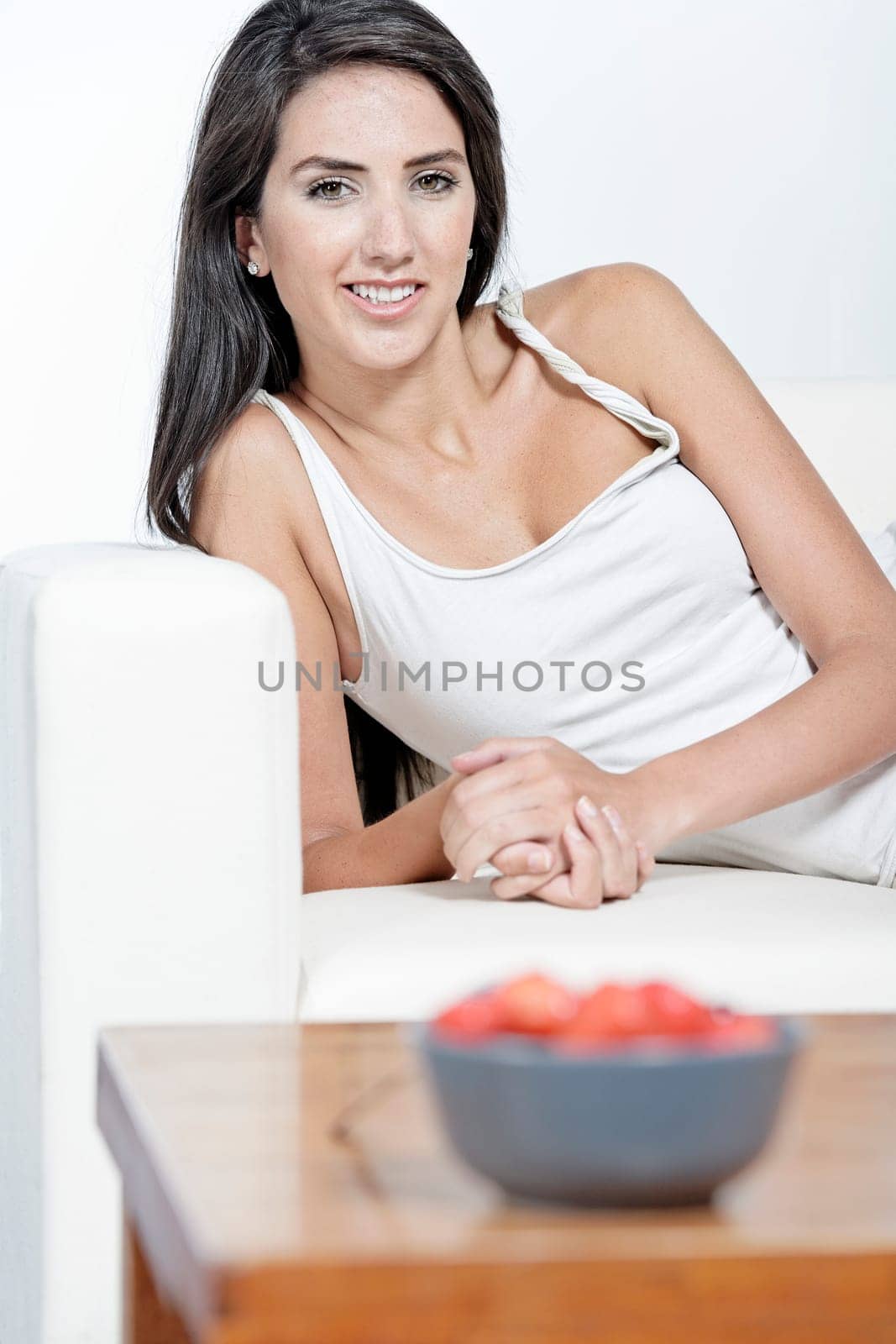 Beautiful young woman enjoying fresh fruit for breakfast at home