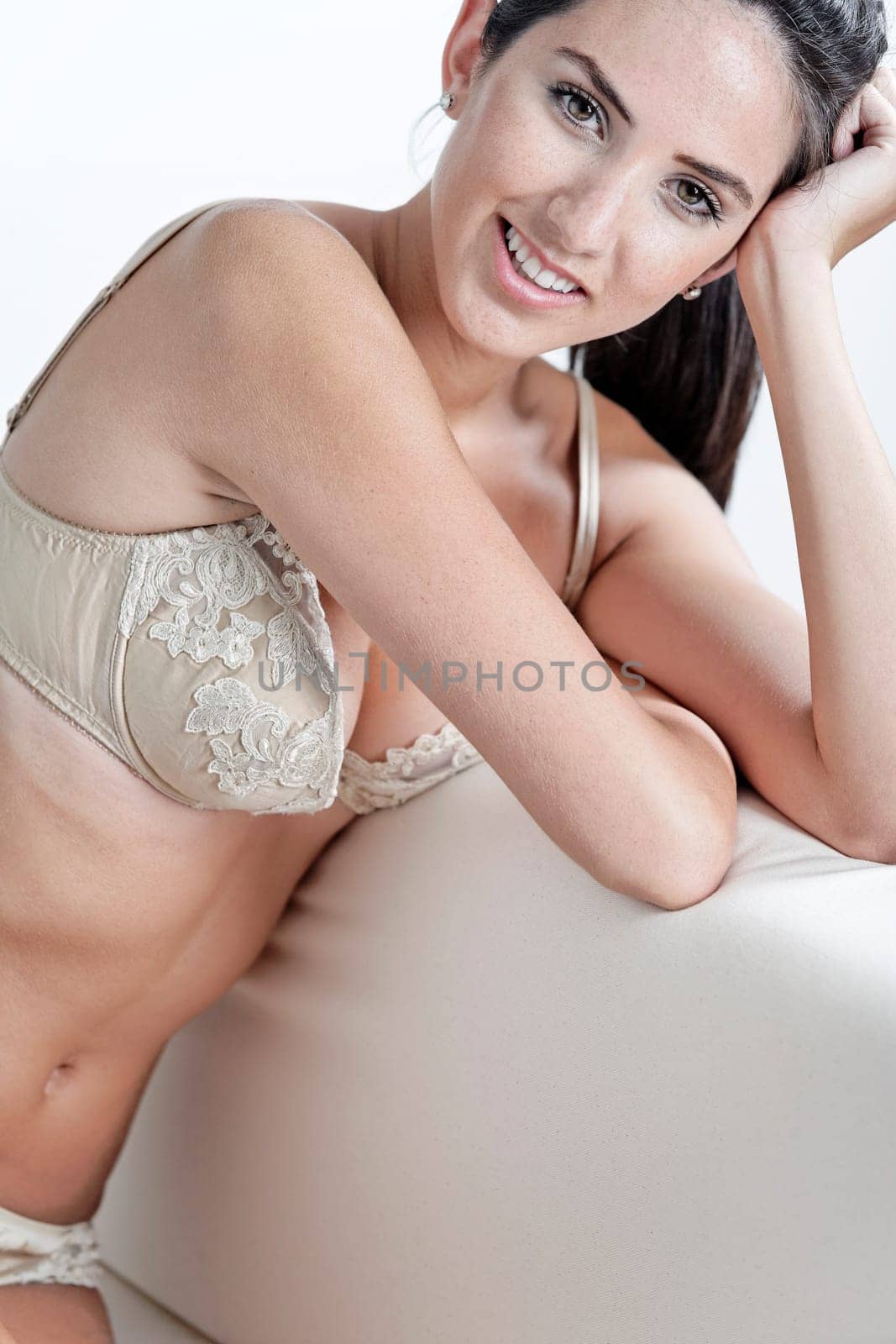 Sexy young woman in cream underwear
