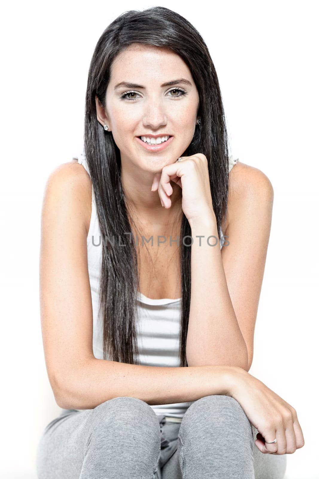 Beautiful young woman in casual clothes resting on white sofa at home