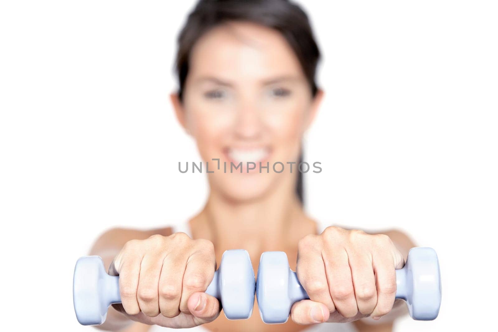Beautiful young woman training with weights at home