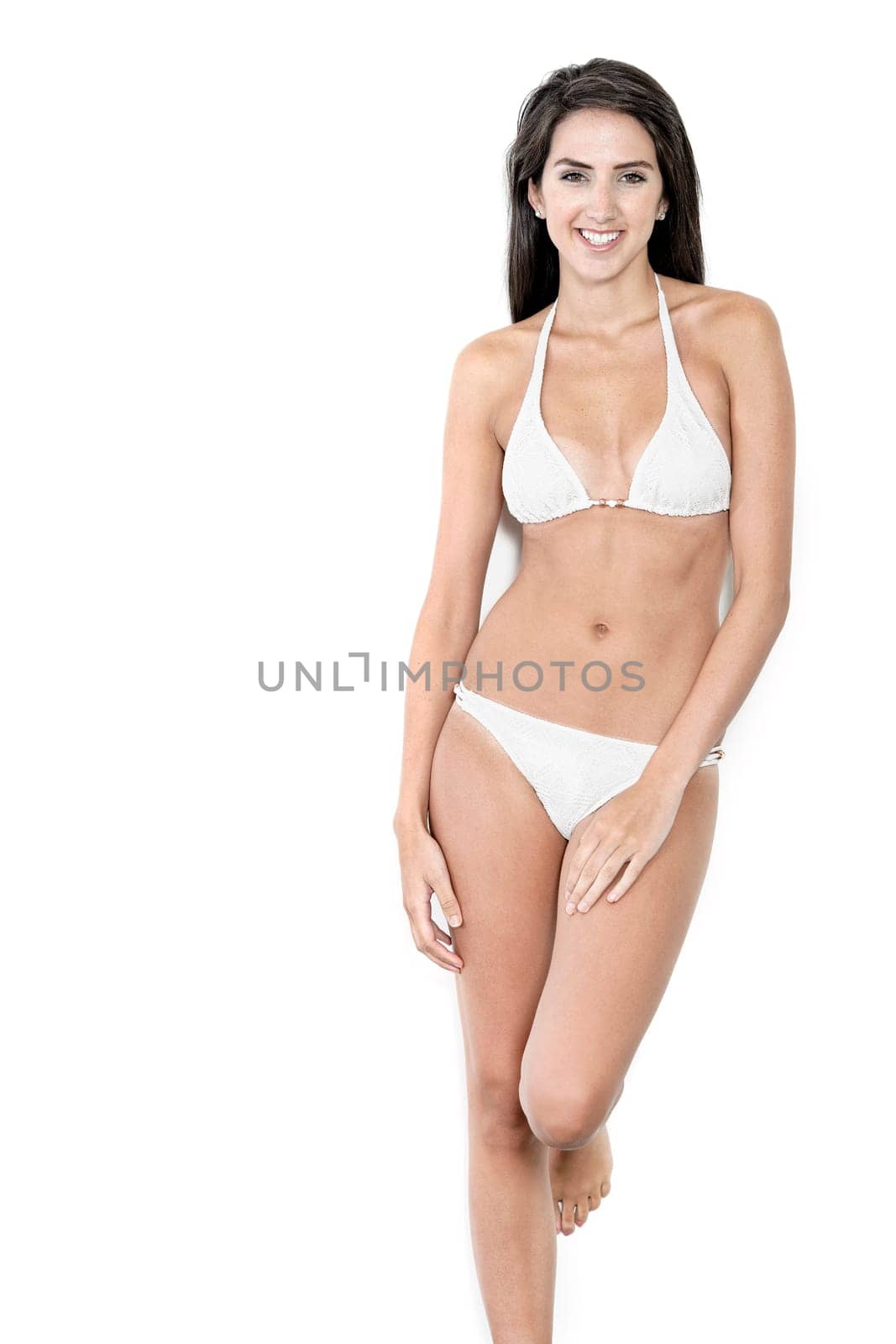 Beautiful sexy woman in white bikini smiling and cheerful