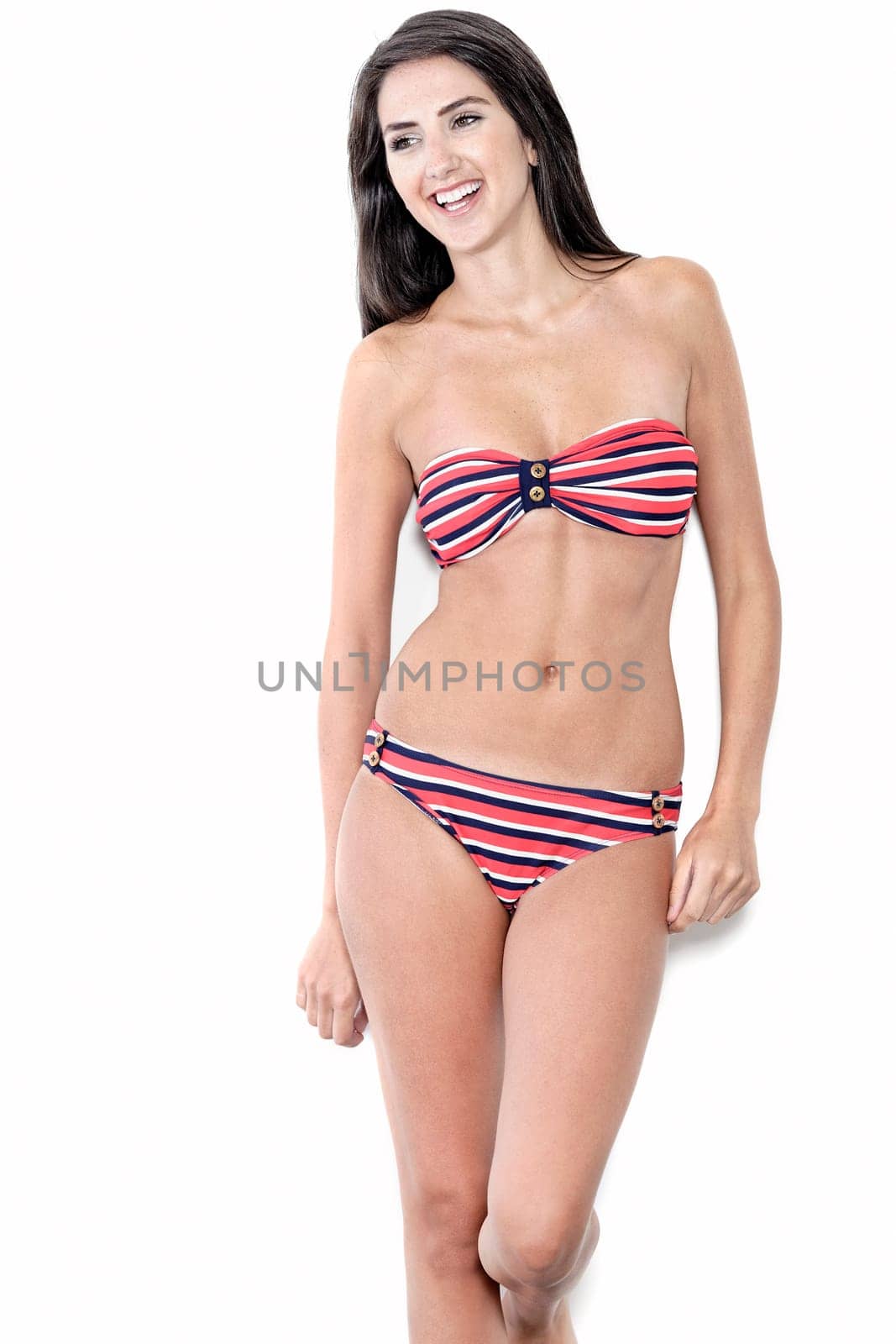 Beautiful sexy woman in red striped bikini smiling and cheerful