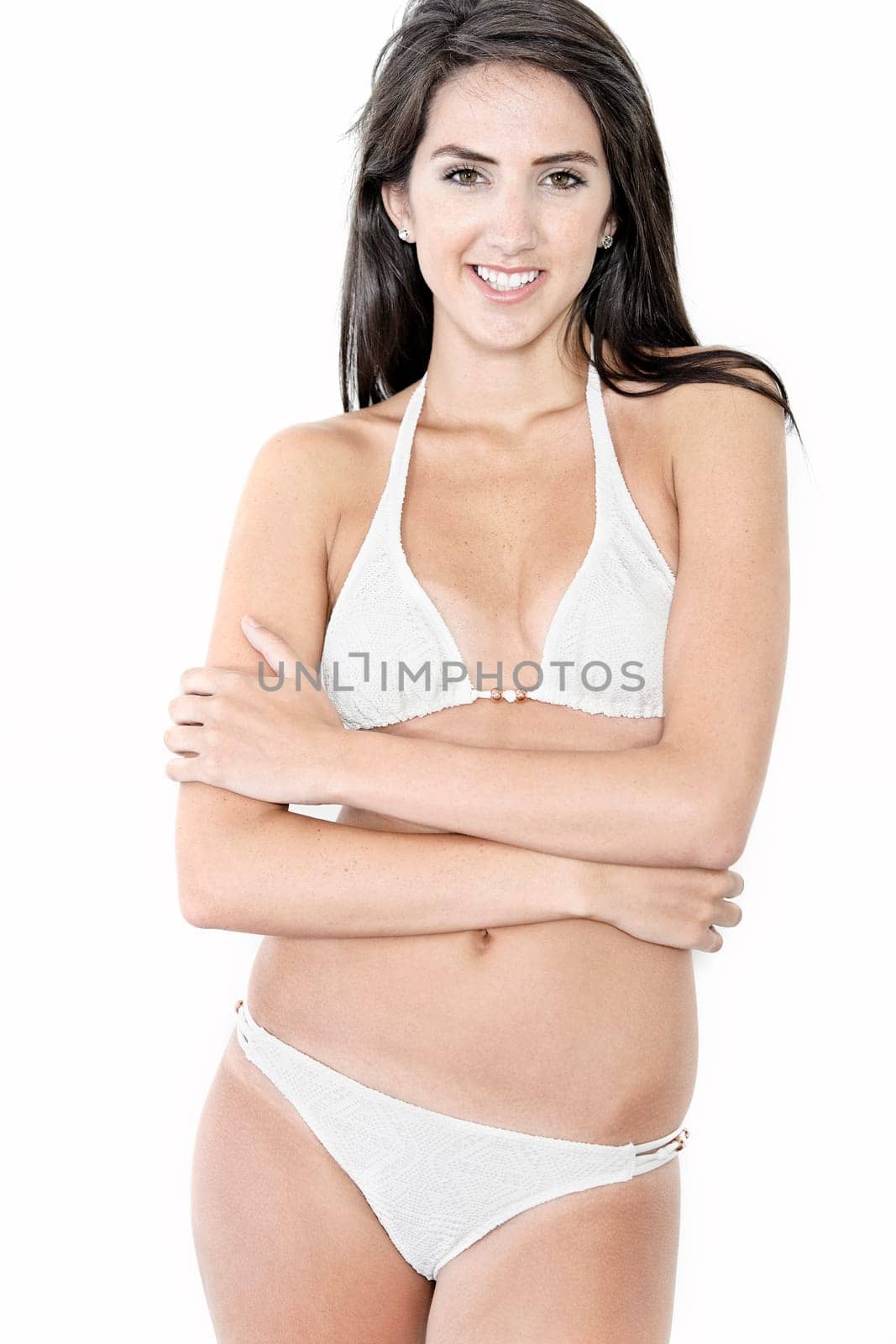 Beautiful sexy woman in white bikini smiling and cheerful