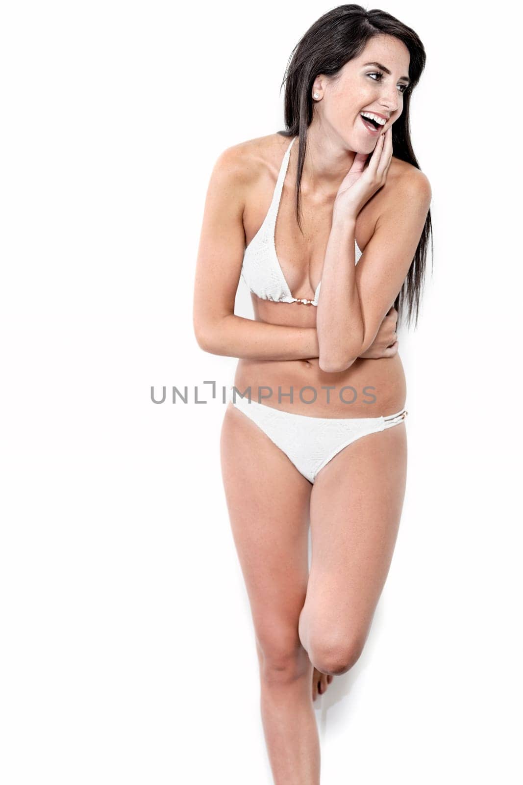 Beautiful sexy woman in white bikini smiling and cheerful
